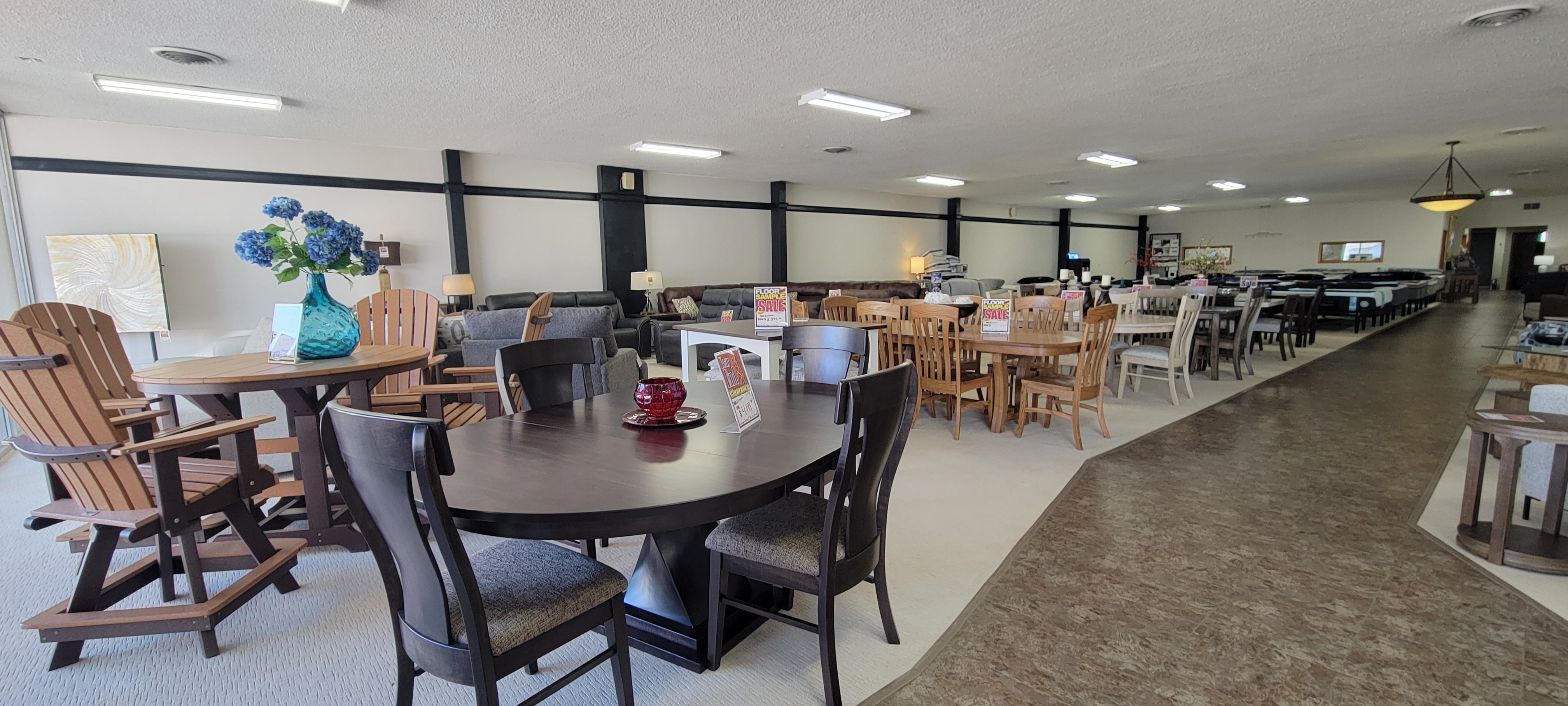 Wide showroom floor with dining tables and outdoor